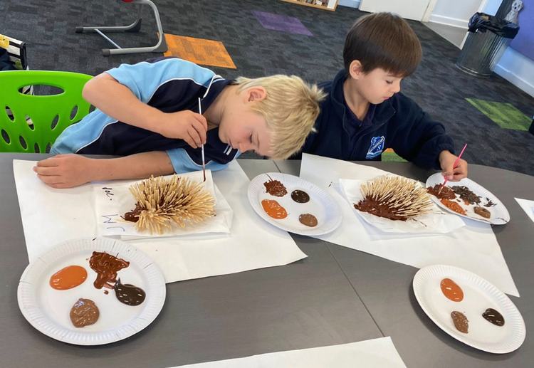 Students creating art work based on a book story