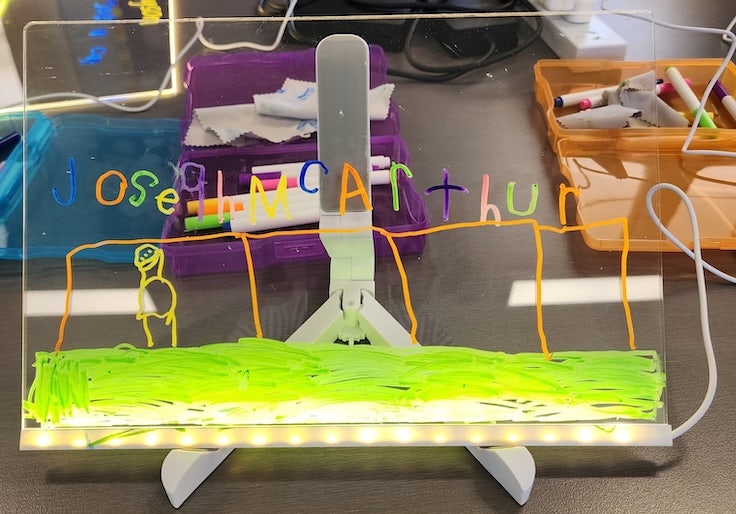 Small screen displaying a drawing by a young student